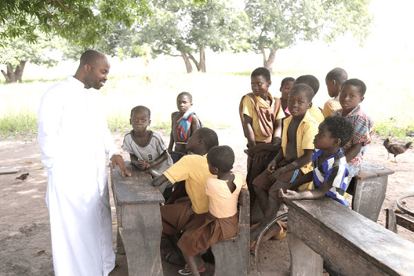 Rev Fr Stephen Sakpaku, the Parish Priest of the St Joseph the Worker Catholic Church at Maame Krobo interacting with the pupils  Rev Fr Stephen Sakpaku, the Parish Priest of the St Joseph the Worker Catholic Church at Maame Krobo interacting with the pupils