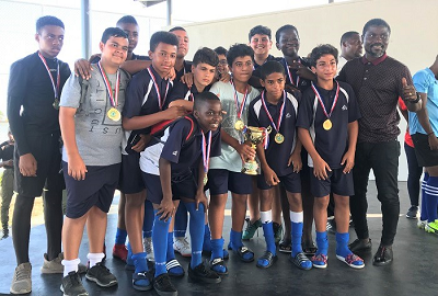 The ARIS Junior Division football champions pose with their coach, Laryea The ARIS Junior Division football champions pose with their coach, Laryea