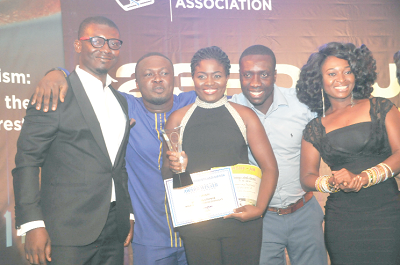 Ms Alice Aryitey of GhOneTV displaying the Most Promising Journalist of the Year Award, which she won