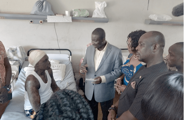 Mr Eric Nana Agyemang-Prempeh (2nd left), the Director-General of NADMO, handing over a cheque to Mr Kasim Suraj