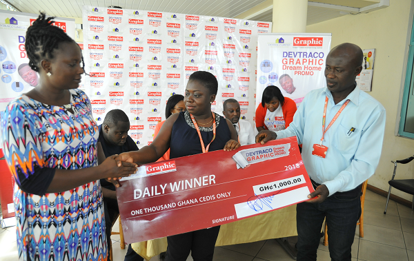 Grace Antwi (right) receiving her prize during the Week-Eight draw held at the GCGL head office