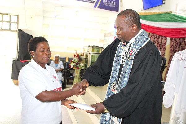Rev Ansa presenting the cash to Mrs Wiafe