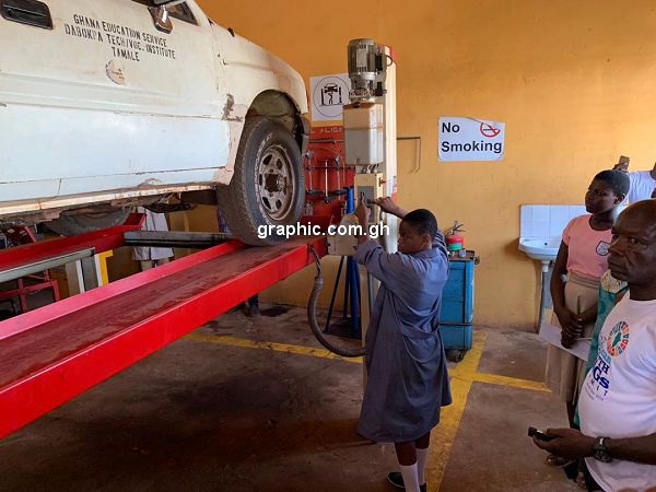 A female student demonstrating her skills on Automotive engineering