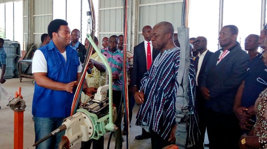 Mr Kwadwo Safo Jnr (left) taking the Vice-President through the vehicle manufacturing  process 