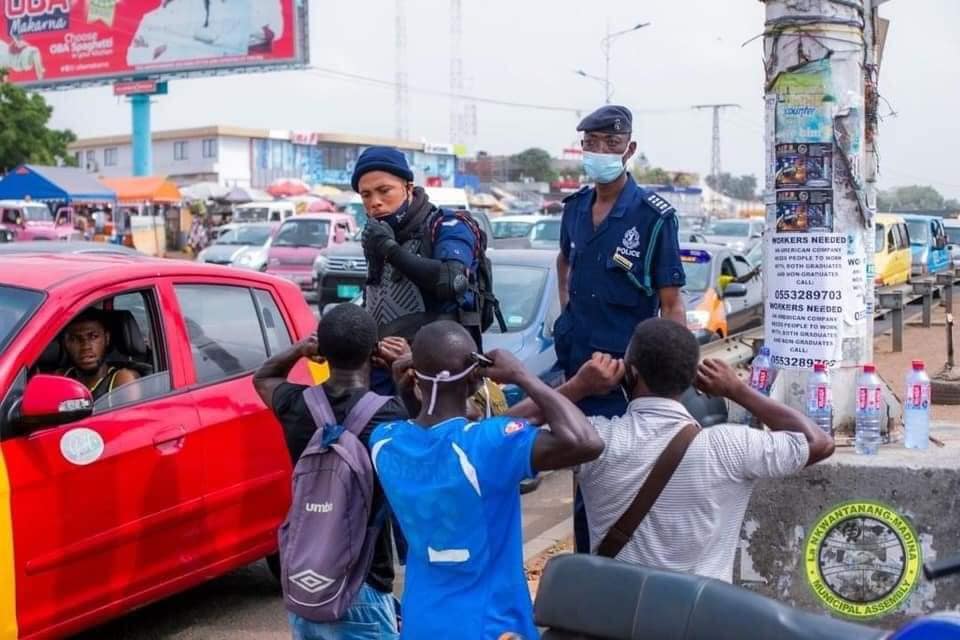 Three men do the squats as punishment for failing to use the footbridge provided at Madina