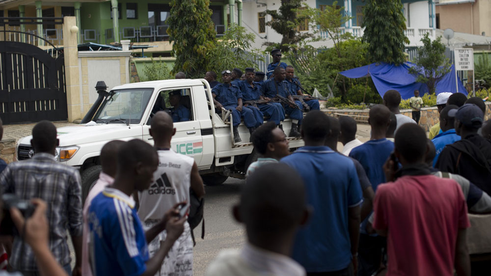 Armed police drive past a group of students taking refuge next to the US embassy [Phil Moore/Al Jazeera]