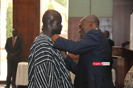 Vice President Amissah Arthur decorating one of the health workers at the awards ceremony. Picture by Ebow Hanson