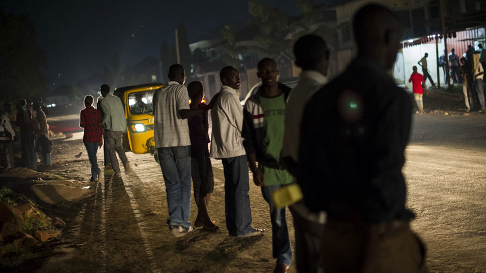 Later in the evening  students who had taken refuge at embassy and have since been forced to leave  stand on the roadside outside the embassy[Phil Moore/Al Jazeera]
