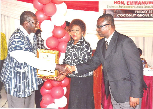 Mrs Bertha de Graft-Johnson (middle) being supported by Mr Francis Deyegbe (right) to receive the award from Mr Kwesi Quartey.