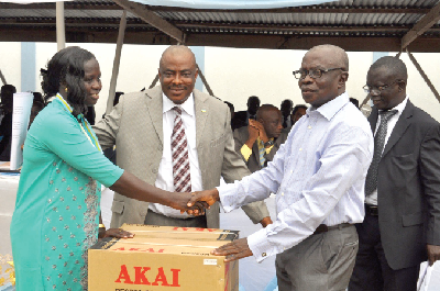 Nana Owusu Sarfo Anwona (right) Vice Chairman of ARB Apex Bank presenting a table top refrigerator to Mrs Margaret Appiah, for serving the bank for over 15 years.  