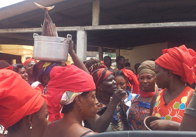 The fishmongers meeting with the chief at the community centre after the demonstration