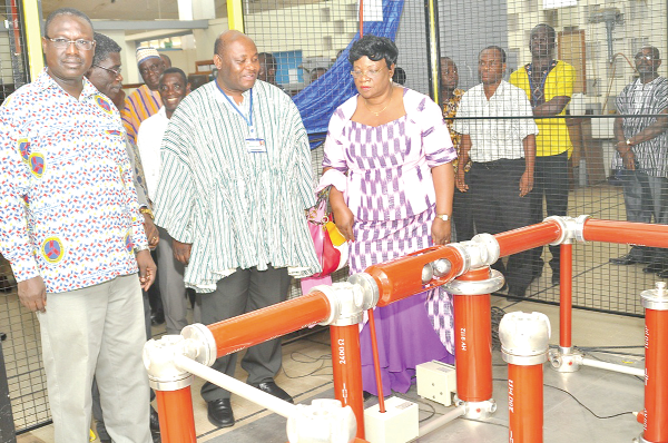  Mrs Perpetua Darfour (right), Board Chairperson of (ECG), inspecting the High Voltage Laboratory after the inauguration ceremony.With her include Prof. Samuel Nii Odai, (middle) Pro -Vice Chancellor of (KNUST) and Eng. William Hutton-Mensah (left), Managing Director of (ECG). Picture: John K. Essel, Kumasi.
