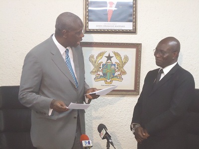 • Mr Van Lare Dosoo (left), Board Chairman, Ecobank shows a cheque to Mr Frank Odoom, the outgoing Director General, SSNIT.