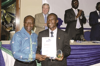  Mr Ken Ofori-Atta congratulating Mr Stephen Kwame Amemakakpor of KEK Insurance Brokers.