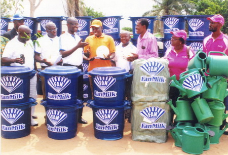 Mr Kwasi Attuah (3rd left), the Sales and Marketing Manager for Fan Milk Limited, presenting the package from Fan Milk Limited to Mr Adams Nuhu (4th left). 