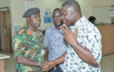 Mr Nehemia Owusu Achiaw (R), News Editor of Daily Graphic, welcomes Col Atintande to the newsroom