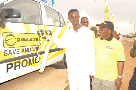 Musah Yakubu Zinah, winner of the Save and Win promo, opening the door of his brand new Hyundai i10. With him is Mr James F. Brew (2nd left), Head of Accounts, Global Access Saving and Loans. Picture: Emmanuel Asamoah Addai 