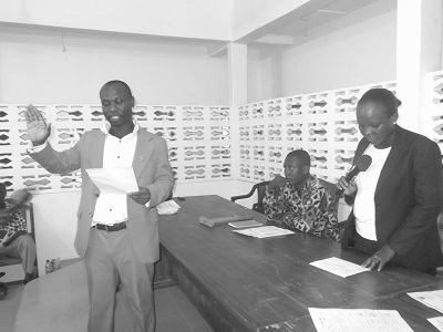 Mrs Cynthia Andy (right), Magistrate at Gomoa Dawurampong Magistrate’s Court, swearing in Mr Frederick Joe Arthur, new Presiding Member of the Gomoa East District Assembly.