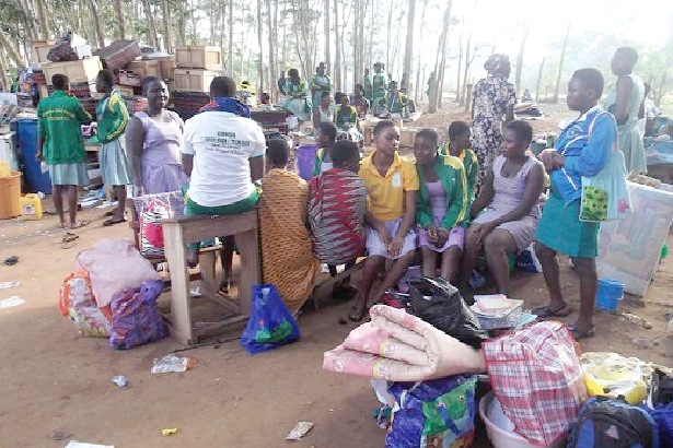 Some of the students seated by their belongings after the incident