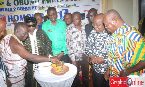 Nii Amarkai III (left), the Asere Djasetse, being assisted by Dr Henry Seidu Daannaa (in smock), the Minister of Chieftaincy and Traditional Affairs, to mix Kpoikpoi to symbolise the launch of 2013 Homowo. Picture: Emmanuel Baah