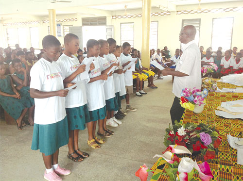 The Volta Regional Editor of the Daily Graphic, Mr Tim Dzamboe, swearing-in the executive of the club.