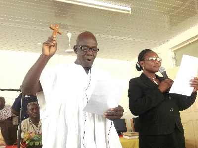 Mr George Nonterah being sworn into office by the District Magistrate, Mrs Comfort Apalayine. 