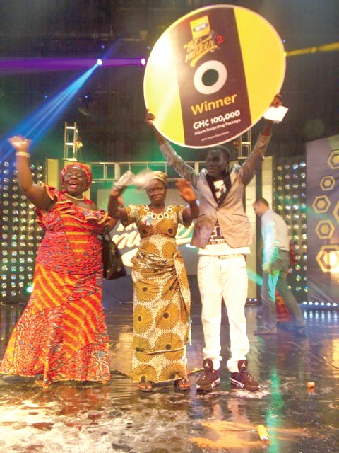 A proud Ntakara raises his dummy cheque