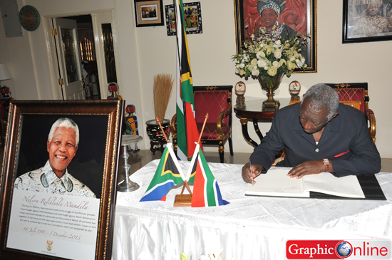 • Former President Kufuor signs the book of condolence in memory of Mandela at the residence of the South African High Commissioner