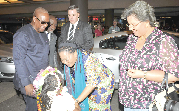 Mrs Lordina Mahama receiving a bouquet to welcome her and President Mahama (left) to their hotel in New York. To the left of Mrs Mahama is Ms Hannah Tetteh, Minister of Foreign Affairs. Pictures: EBOW HANSON