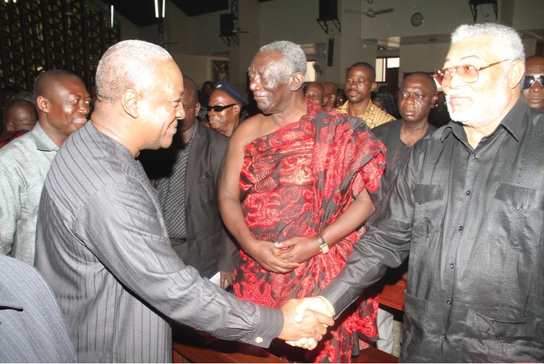 President Mahama shaking hands with former President Jerry John Rawlings, while former President John Agyekum Kufuor looks on, during the funeral mass.