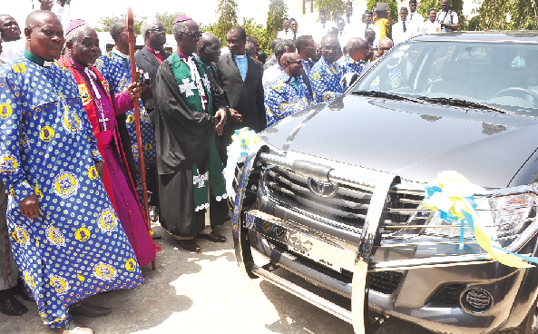 The Very Rev. Thomas B. Forson (left), Synod Secretary and Bishop Winfred Ametefe (2nd left) admiring a new pick-up presented to the retired minister. Picture: SAMUEL TEI ADANO.