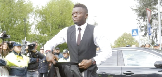  Time for serious business: Sulley Muntari  arrives at his office, 4FK MotorSport, where cars are pimped for millionaires and super stars.