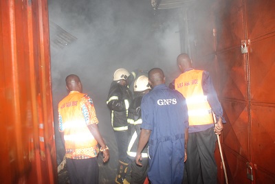 The security personnel were at the entrance of the Pedestrian Shopping Mall to ensure safety. INSET: One of the victims carrying her sewing machine to safety.Picture: EMMANUEL BAAH