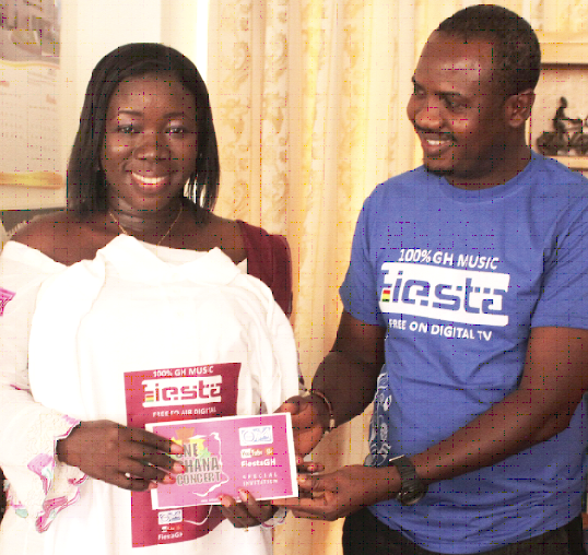 Mr Isaac Martey, Production Manager at OM, presenting a special ‘One Ghana’ concert invitation to the Minister of Tourism, Culture and Creative Arts, Mrs Elizabeth Ofosu Adjare.