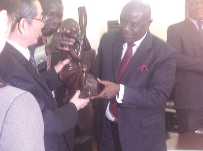 Mr Doe Adjaho (right) presenting a gift to Mr Ma Biao