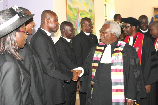 The Moderator of the General Assembly of the PCG, Reverend Professor Emmanuel Martey, congratulating the new  ministers on their commissioning.