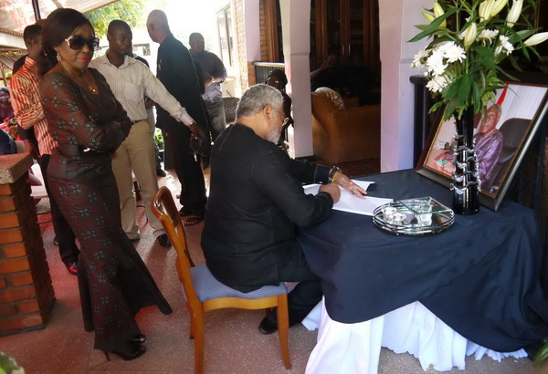 Flt Lt J. J Rawlings signing the book of condolence at the late Awoonor's residence