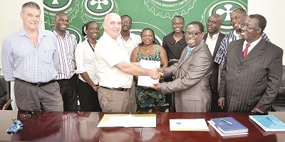 Mr Metcalf (4th left) presenting the MoU to Rev. Prof. Nyarko in the presence of officials of ABL and the polytechnic.