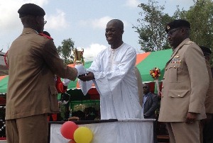 Vice President, Mr Kwesi Amissah-Arthur presenting the overall best officer cadet award to Charles Kwaku Mensah.
