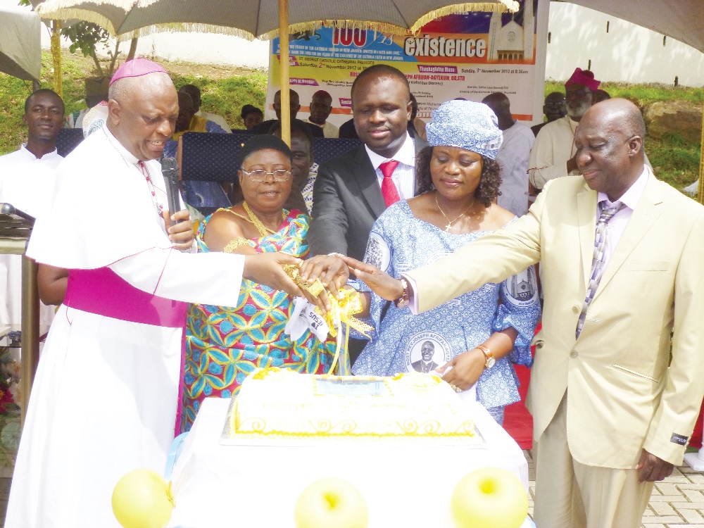 The Most Rev Joseph Afrifah-Agyekum (left) being assisted by the Queenmother of New Juaben, Nana Yaa Daani (second left), and Ms Helen A. Ntoso, the Eastern Regional Minister, to cut the centenary cake.