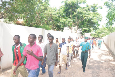 The Nigeriens being escorted to board a vehicle to their country
