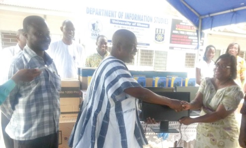 Prof. Perpetual Dadzie (right) receiving the items from Kofi Attor, CEO of GIFEC, while some staff of the department and GIFEC look on.
