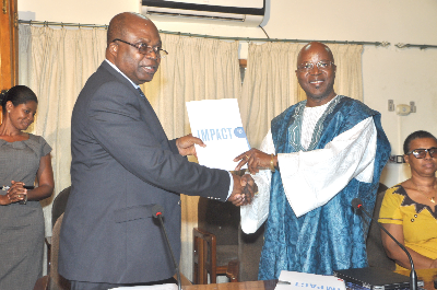 Mr Clement Kofi  Humado (left), Minister of Food and Agriculture and Dr Lamourdia Thiombiano, the FAO Country Representative, exchanging the signed document at a ceremony in Accra. Picture: GABRIEL AHIABOR