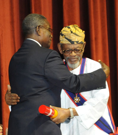 FLASHBACK: Harry Sawyerr being embraced by late President J.E.A. Mills shortly after he was decorated with the highest state honour