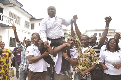 Mr Ken Kuranchie, the Editor of the Daily Searchlight, enjoying a kingly ride on the shoulders of some NPP supporters after his release from prison. Picture: GABRIEL AHIABOR
