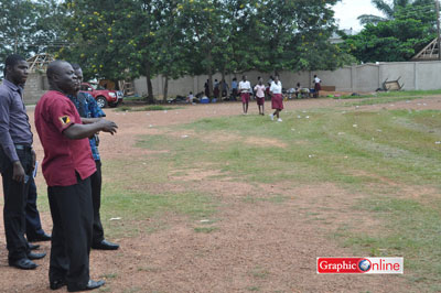 An invigilator at the exam centre showing reporters the field where the incident occured