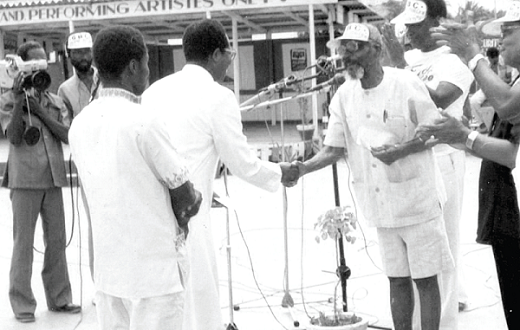   Dr Amu presents a prize to Bro. Pius when his Adehyemma group came out tops at an Amu Choral Festival.