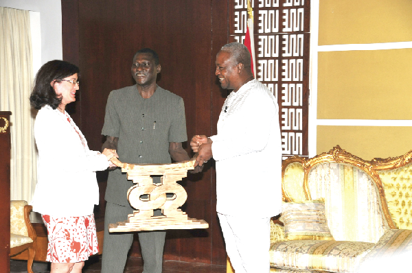 President John Mahama presenting a royal stool to Mrs Olga Carbarga Gomez, the out-going Ambassador of Spain. Looking on is Ambassador Kwame Tenkorang, the Director of State Protocol