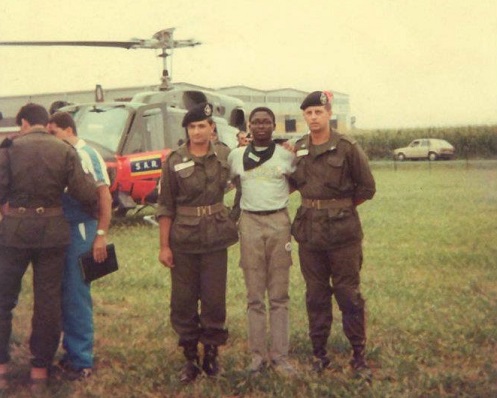 Raymond flanked by some Red Cross personnel in Italy when he won an essay competition.