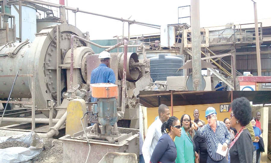 Workers on the plant that process the raw gold waste materials from the mining companies across the country. INSET: Mr R.P Smith (in helmet), CEO of the Gold Recovery Ghana Limited point to the machines as he explains the process to the SA delegation.
